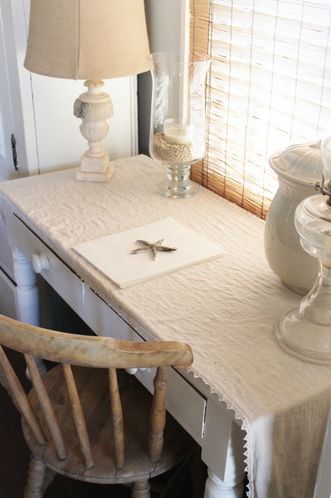 Old linen runner that is a family heirloom along with an antique alabaster lamp.