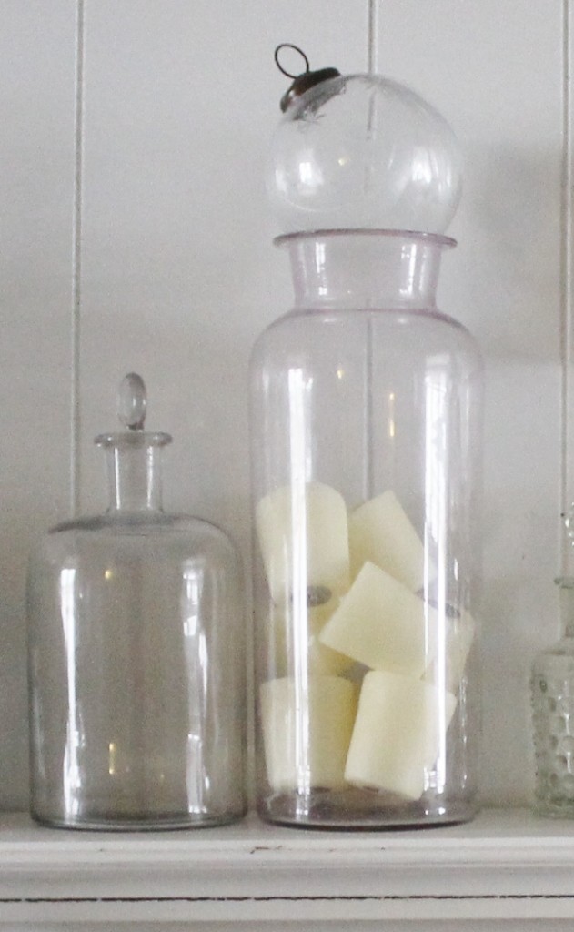 A wide mouth apothecary jar holds lovely scented votive candles. 