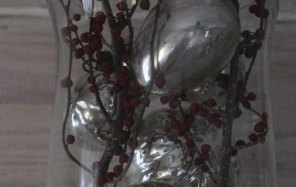 Christmas Pepperberries, now dried juxtopposed against the shiny mercury glass.