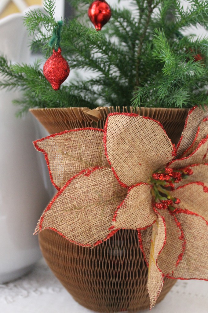 A vintage paper vase cover for a holiday touch with a market item burlap flower embellishment from Michael's ($2.50)
