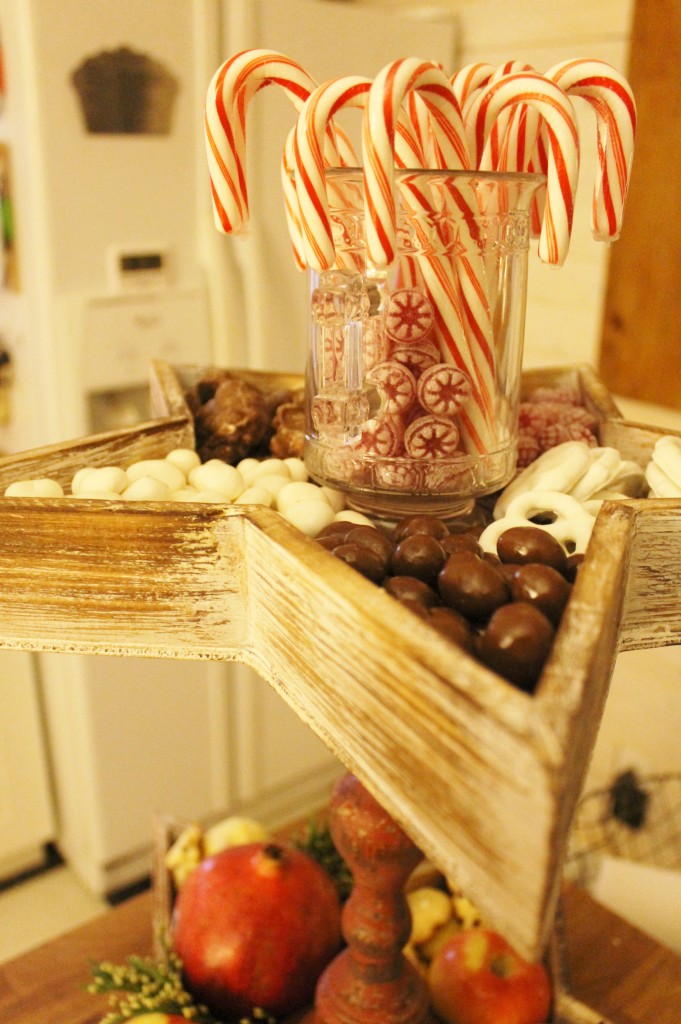 A vintage glass container helps top of the display with cheery candy canes.