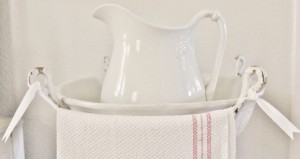 An old ironstone pitcher, basin and vintage towel.