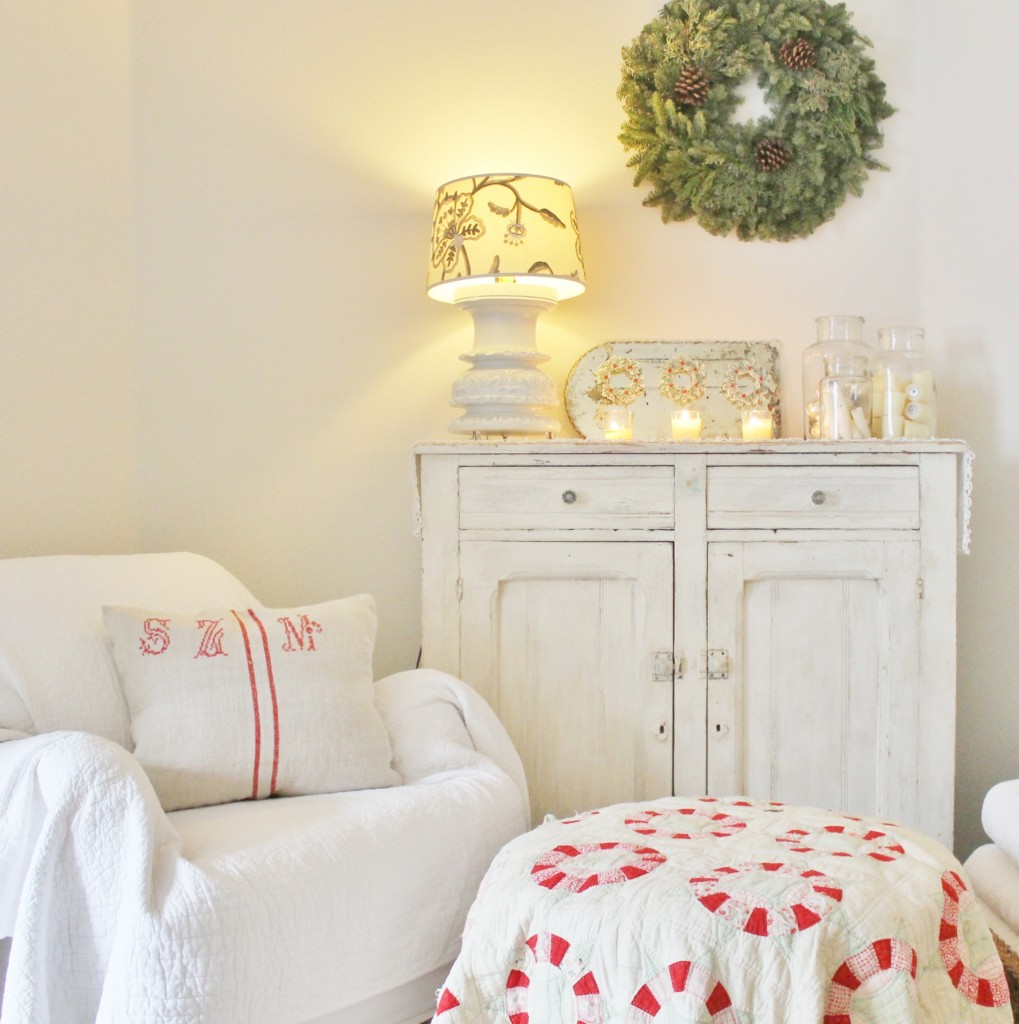A little nook in my apartment with a simple wreath, some candles and a lovely quilt with lovely festive colors for some contrast. 