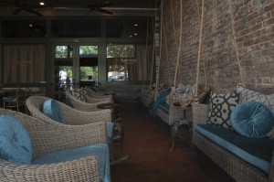 The front porch has these terrific swinging settees with the teal velvet cushions (although it now has tables, great for nice weather dining or drinks)