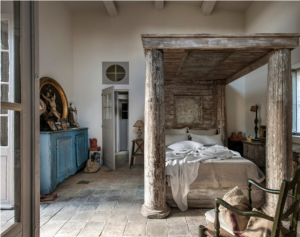 Beautiful French farm house bedroom.  I love the stone floors and the architectural salvage bed.  But mostly, my eye was drawn to the window above the door.
