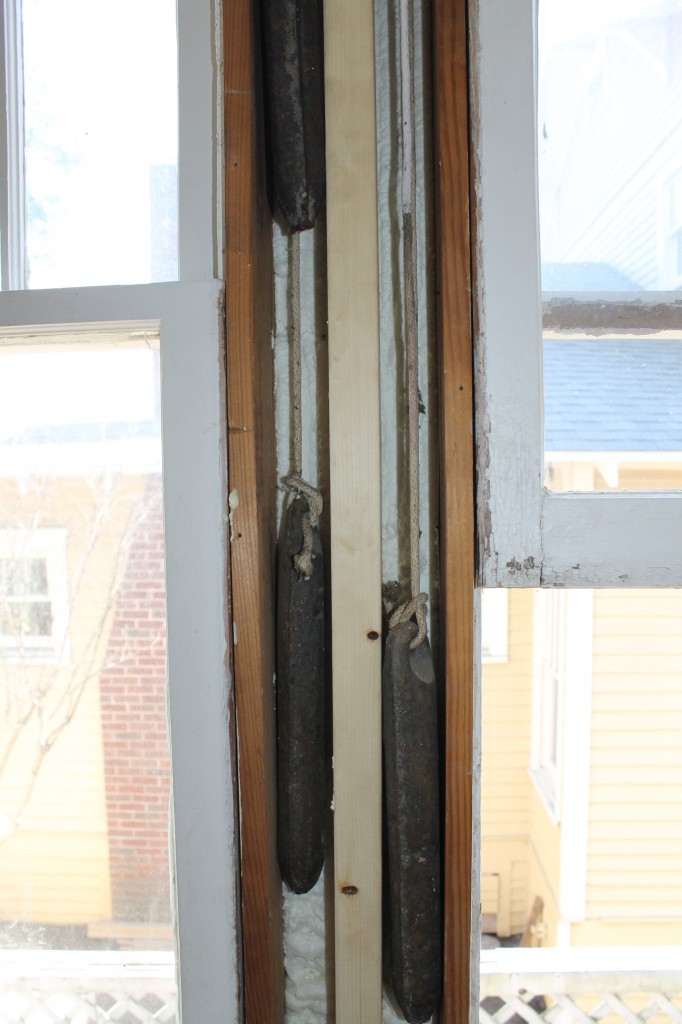 With the trim removed, the old window weights are revealed.  I love old houses.