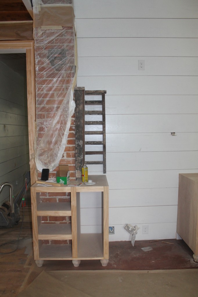Kitchen cabinets built around an original feature of the house, the brick chimney
