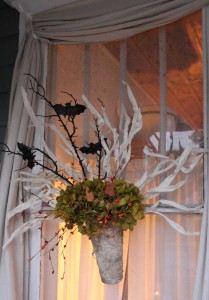 An arrangement of silk hydrangeas, bittersweet berries and ethereal looking paper wisps compliment the Halloween picks found at the local hobby store.
