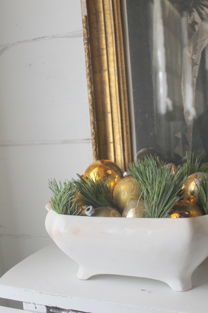 Sprigs of fresh greens, vintage glass ornaments in a simple ironstone bowl.