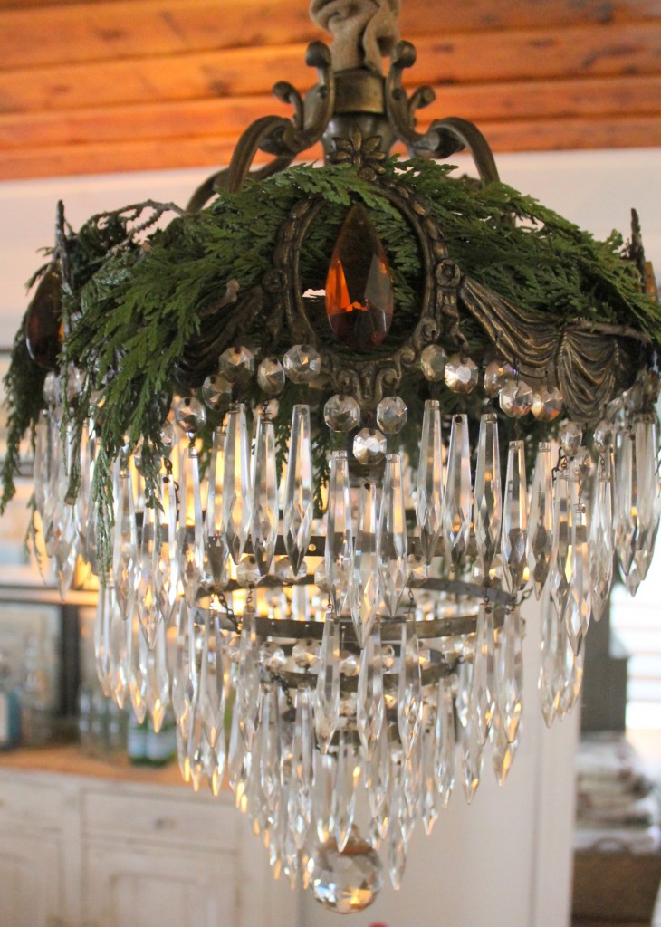 My antique chandelier with a crown of fresh Christmas greens.