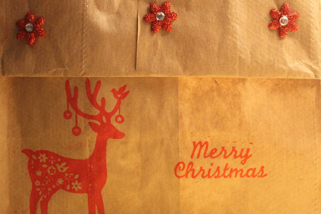 A simple lunch sack folded over, left plain or using holiday stamps and embellishments as I have done.