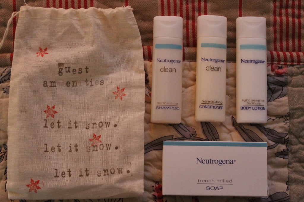 Travel sizes all wrapped in a muslin bag decorated with simple holiday stamps.