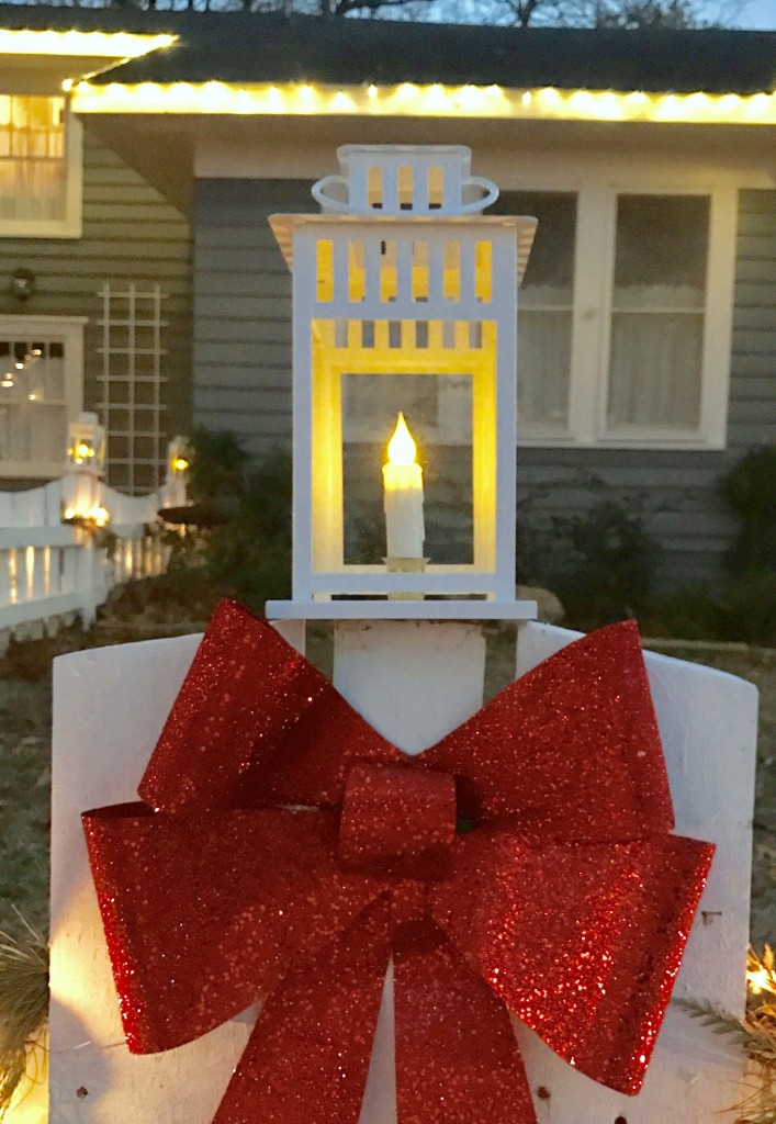 An Ikea lantern with a battery operated candle for each fence post.